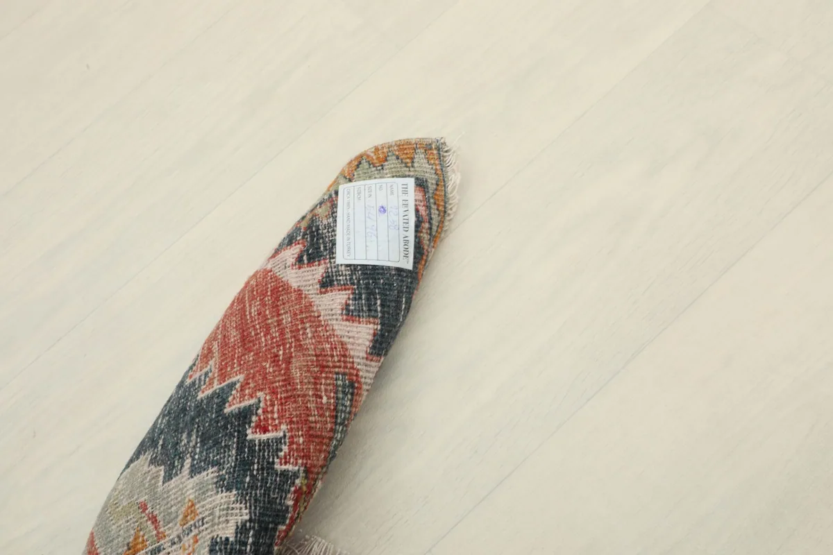 View of the back of the rug, revealing the tightly woven cotton foundation and hand-knotted wool pile.