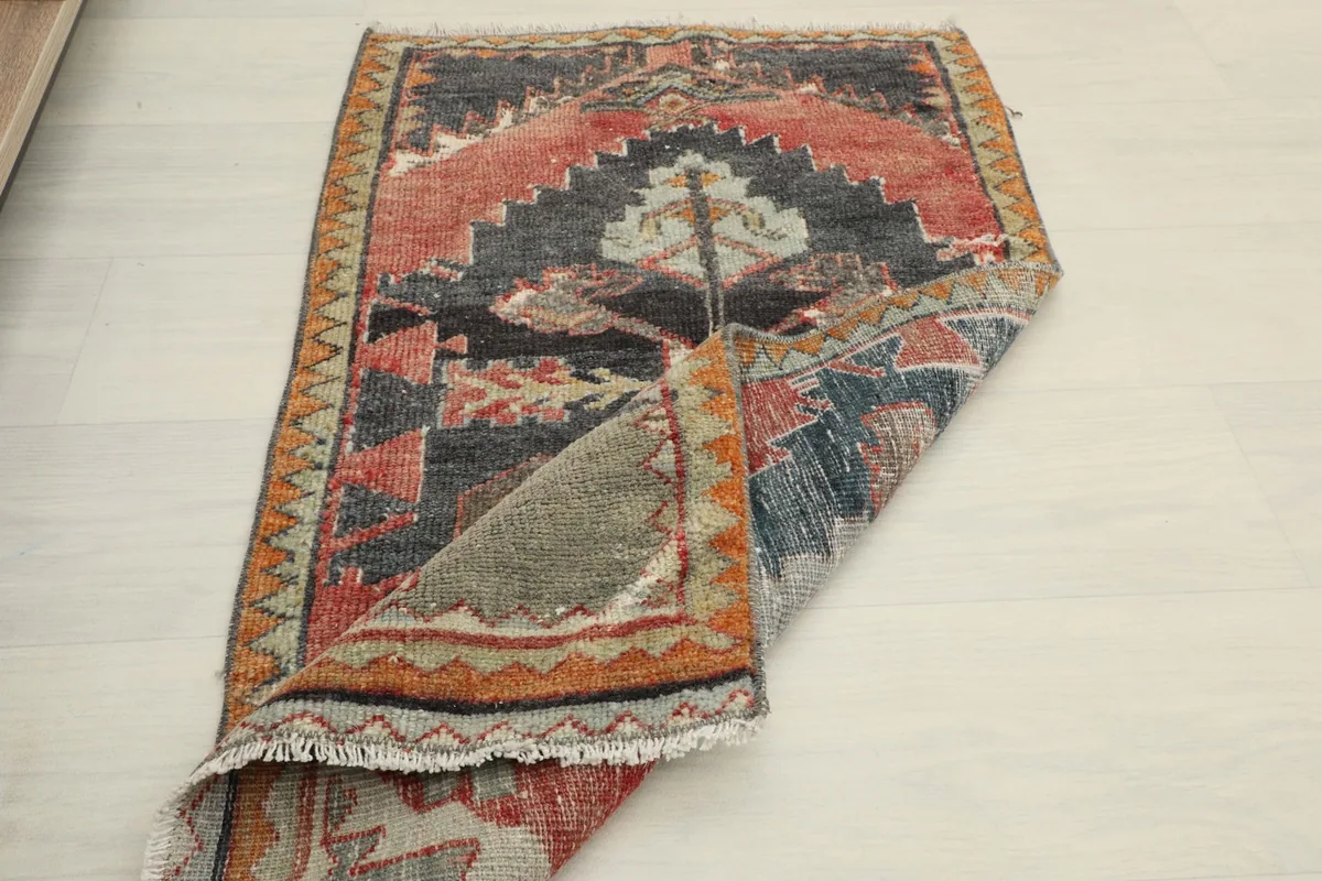 Another folded view of the rug, showcasing its flexibility and the back of the hand-knotted construction.