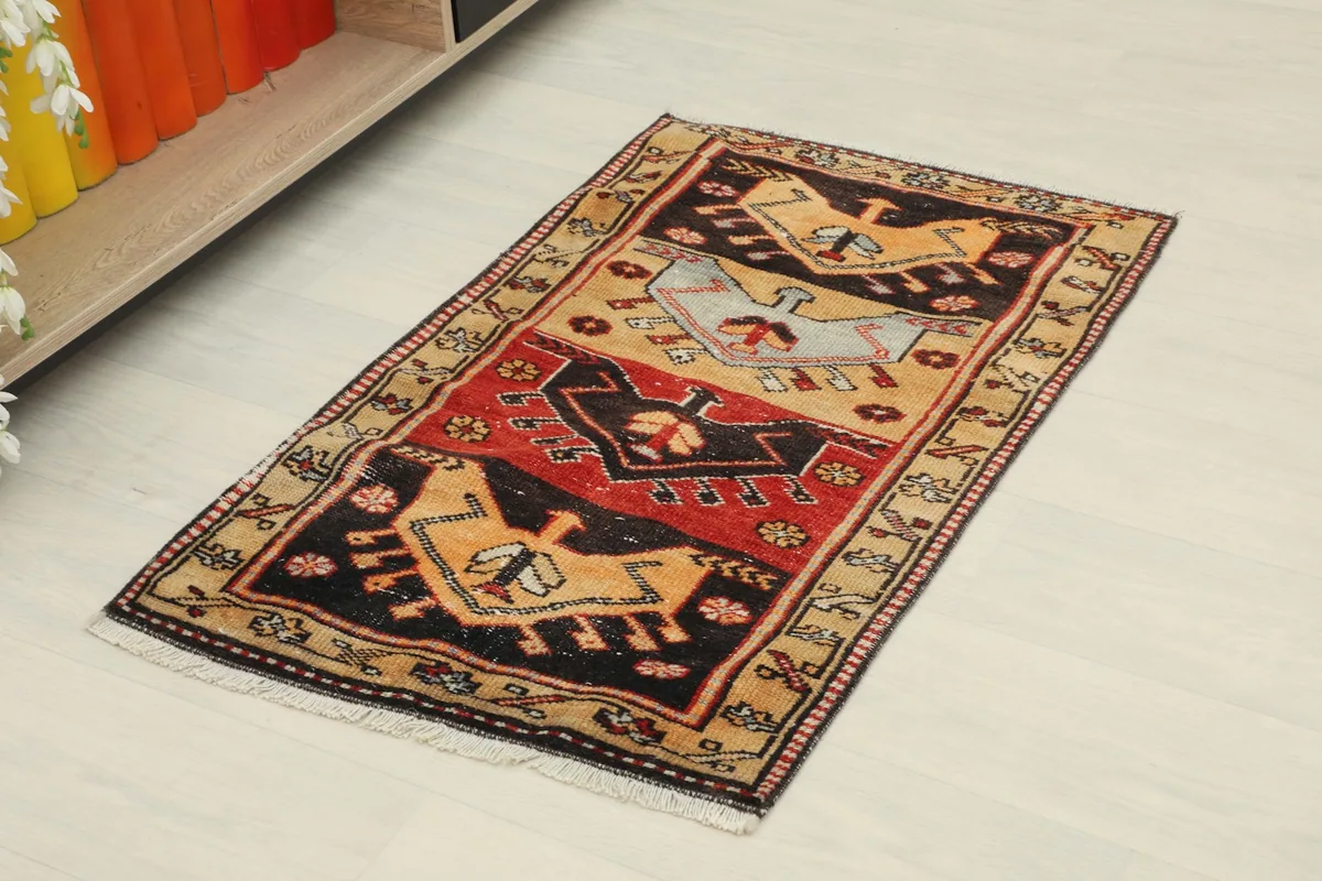 Angled view of the hand-knotted rug, showing its rectangular shape and vibrant colors on a light floor.