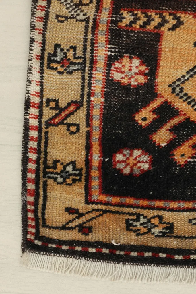 Close-up of a side border and corner, showing the minor wear consistent with its vintage character.