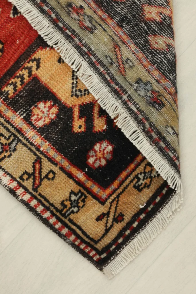 The rug folded to reveal the thickness and the back of the hand-knotted construction.