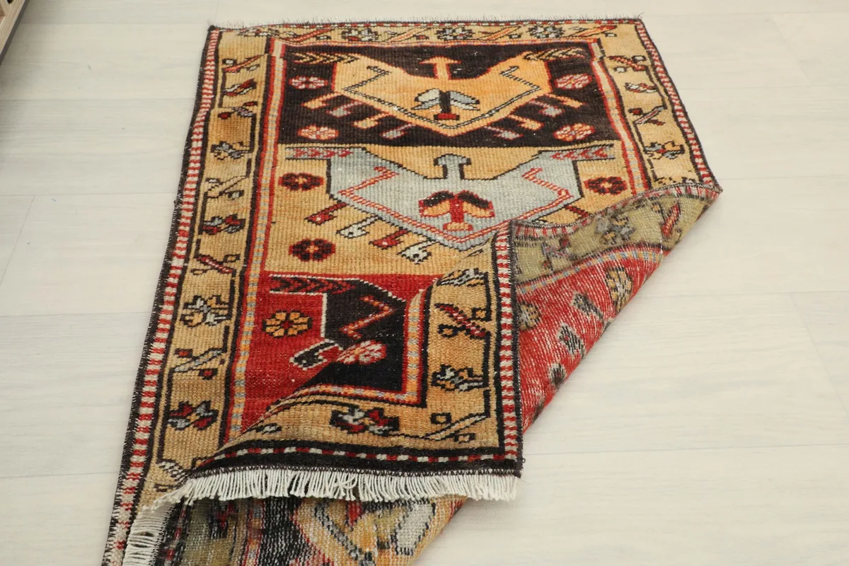 Partially folded rug on a light floor, demonstrating its flexibility and the overall design.