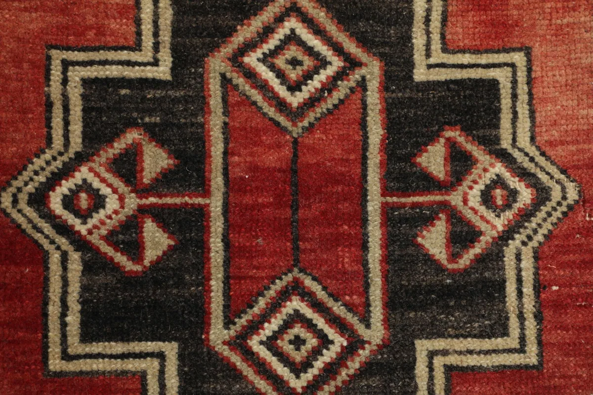 Detailed view of the intricate geometric patterns within the central black and red sections.