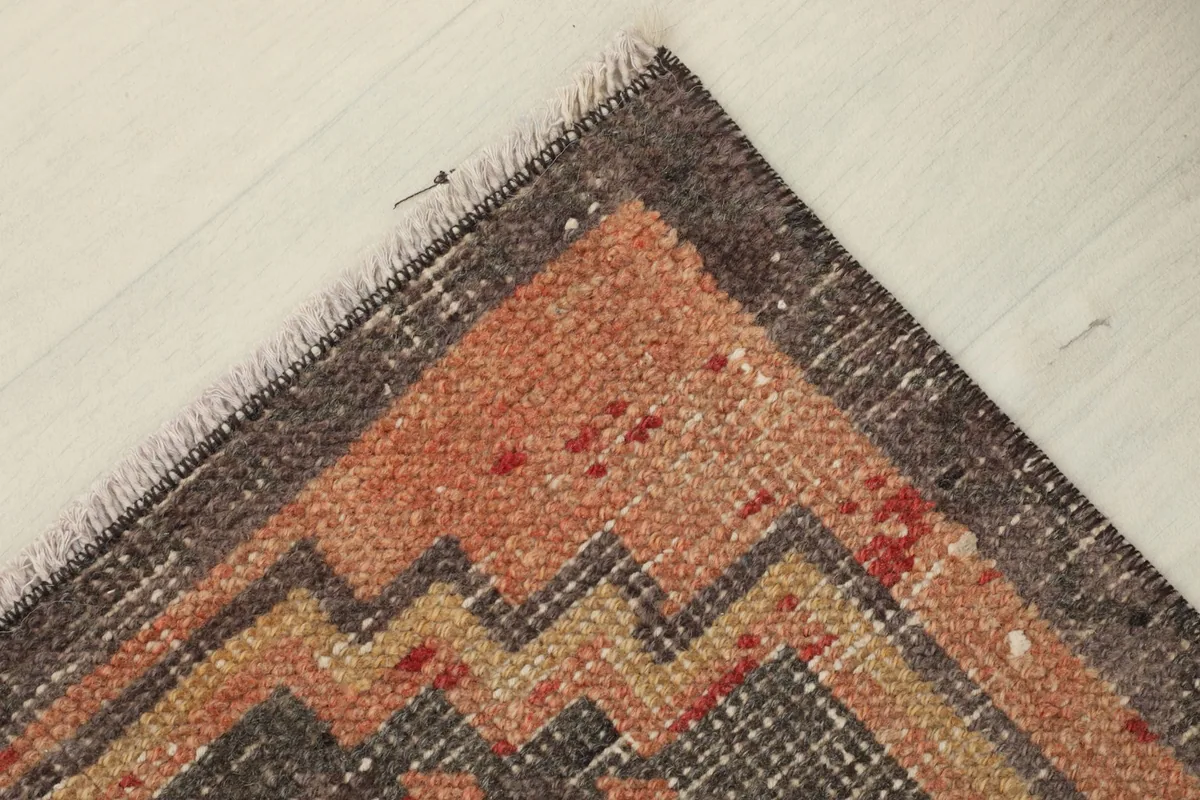 Angled corner view, showing the subtle color shifts and the rug's overall condition.