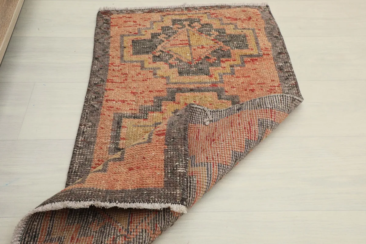 Another folded view, illustrating the rug's flexibility and the hand-knotted construction.