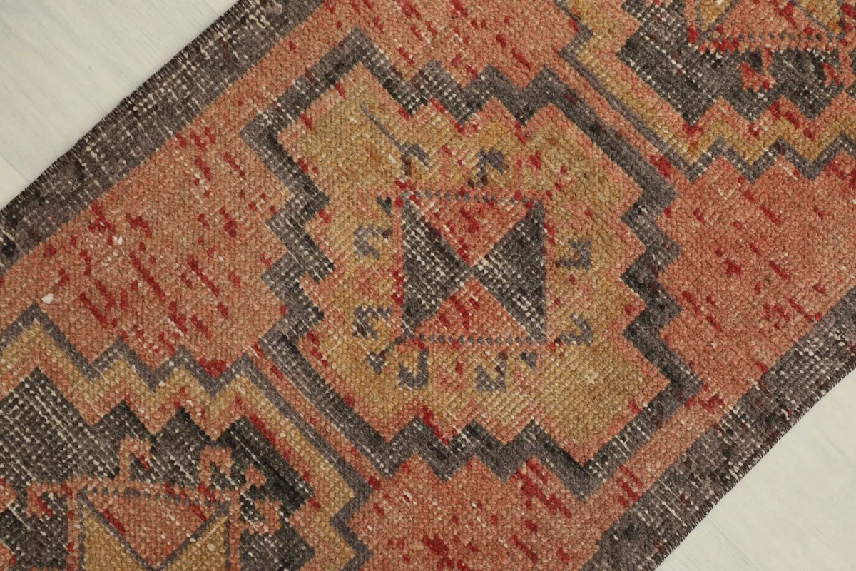 Overhead view showcasing the central geometric motifs and color variations of the rug.