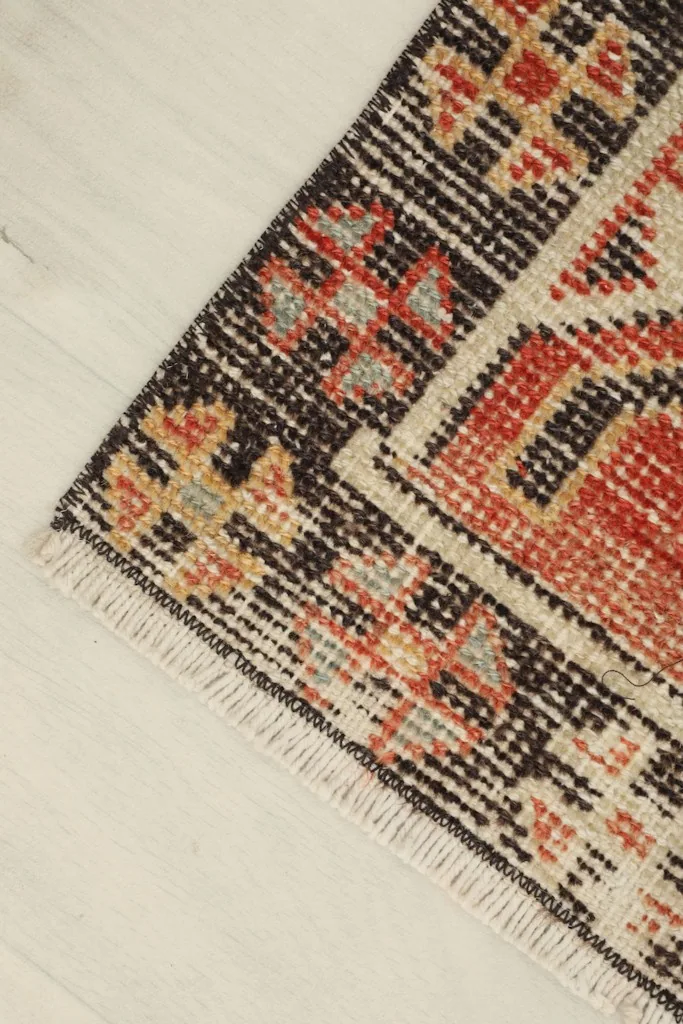 Angled close-up of the doormat's surface, showing the low pile and intricate design