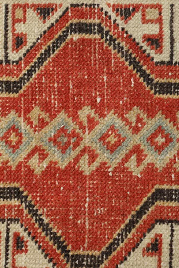 Macro detail of the hand-knotted wool pile, showing the texture and color variations
