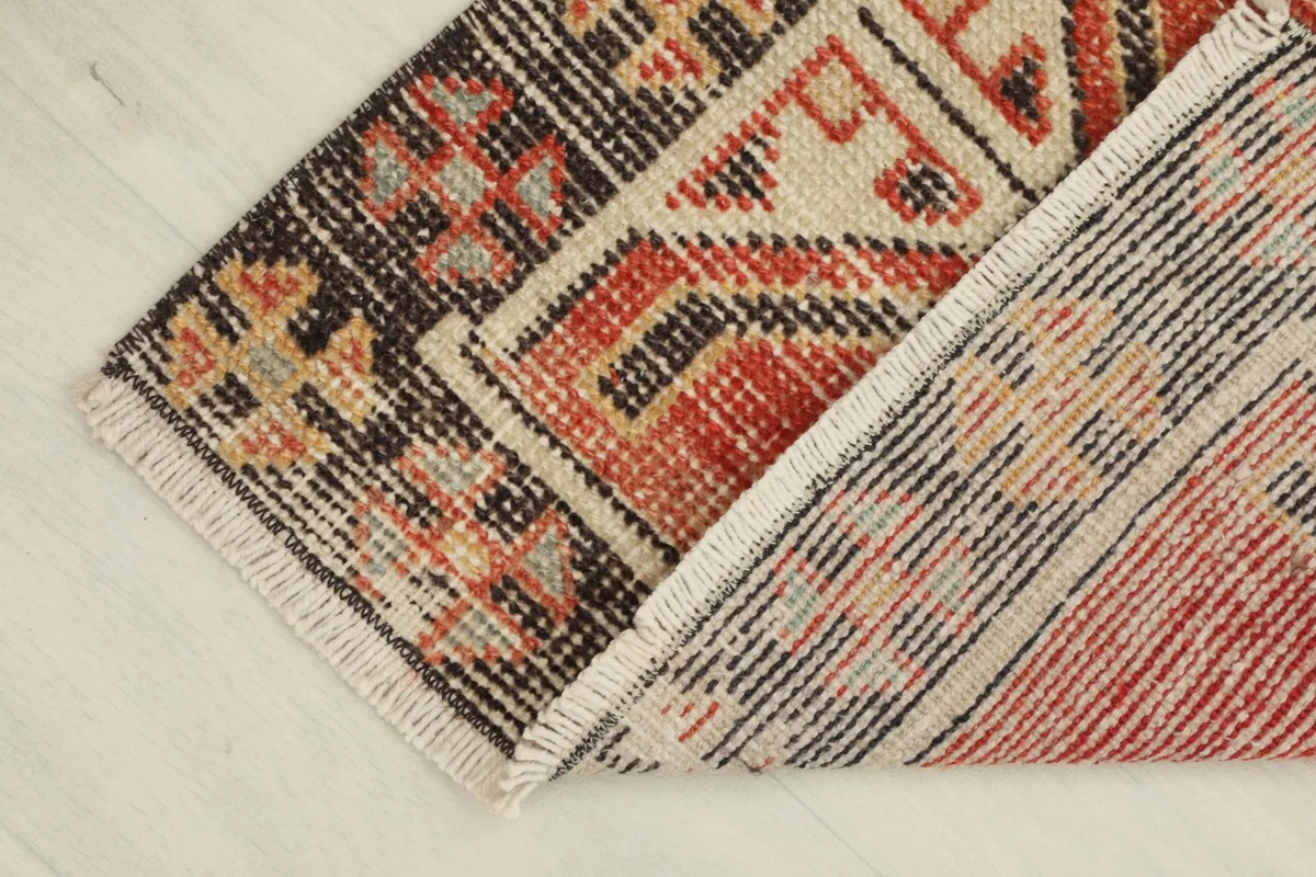 Doormat partially folded, revealing the wool pile on the cotton foundation