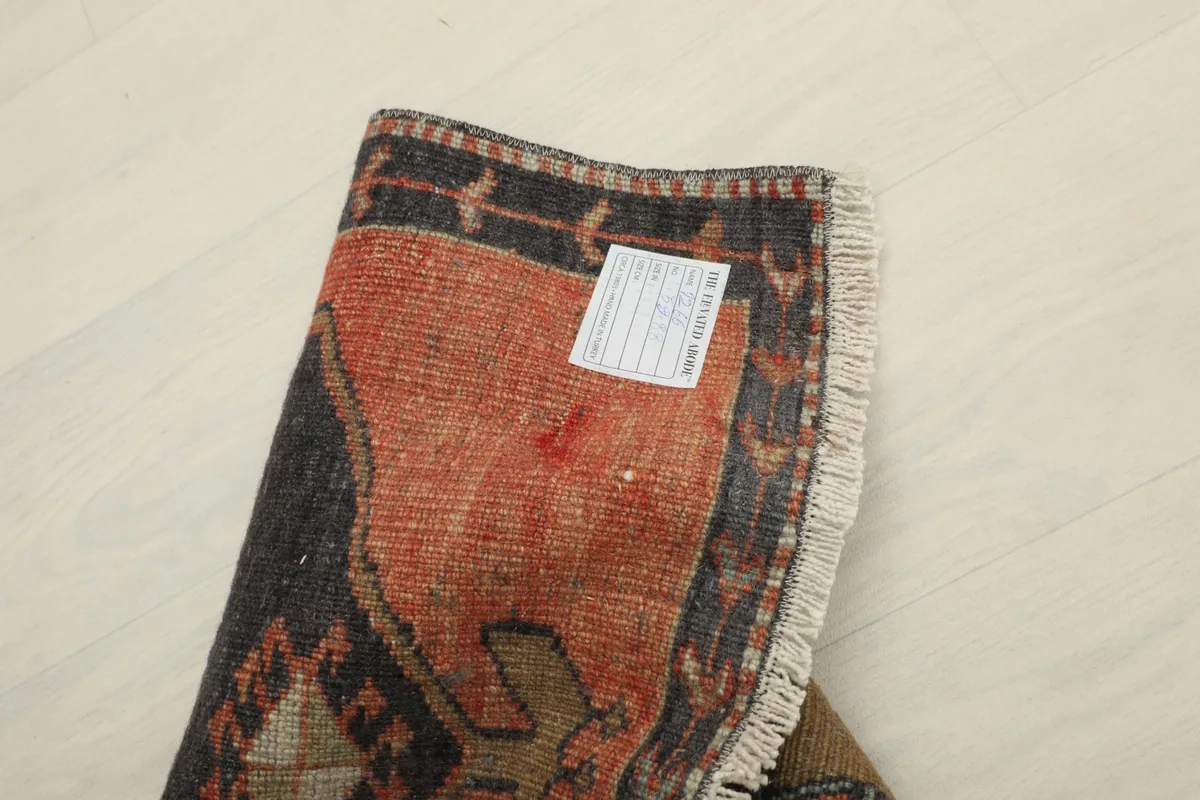 Back view of the rug, showing the cotton foundation and the reverse of the hand-knotted wool pile.
