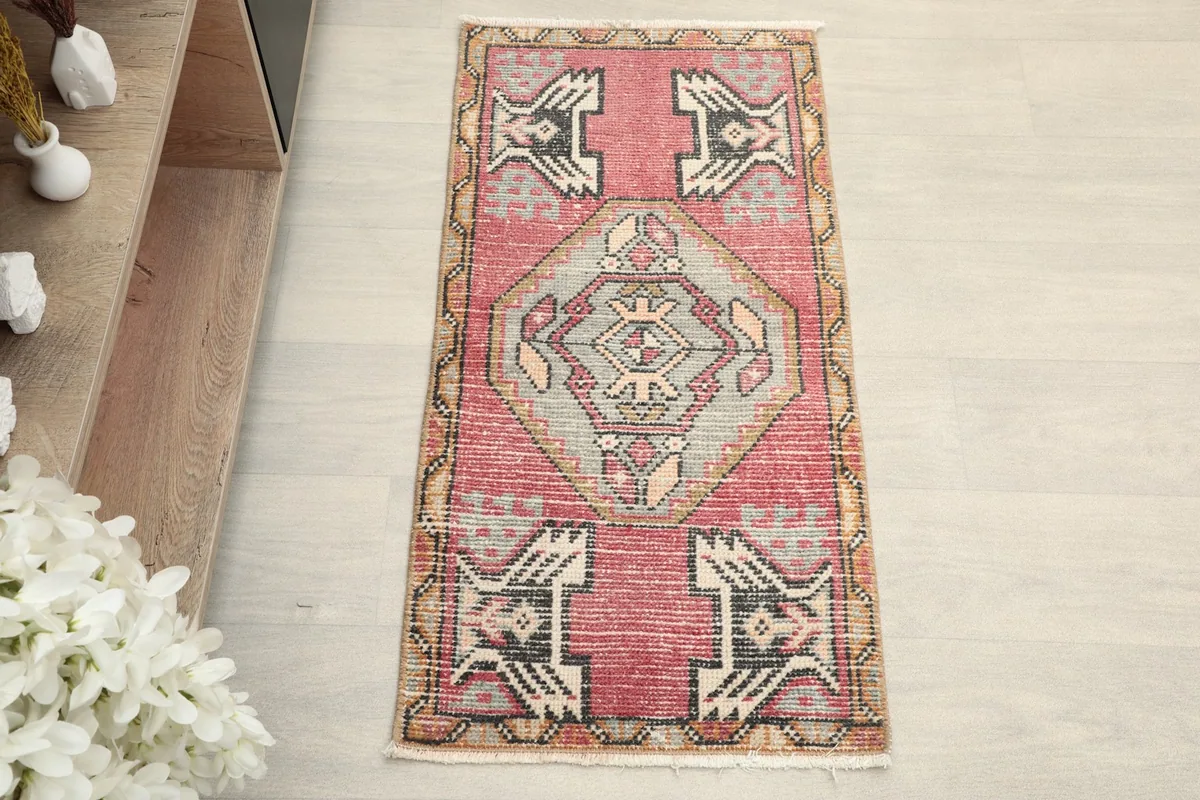 Overhead view of the small hand-knotted rug, showcasing the central medallion and surrounding motifs