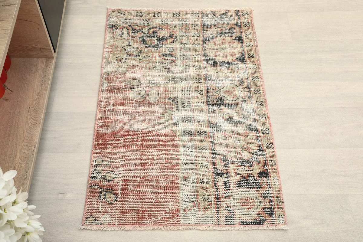 Overhead view showing the full pattern and colors of the rust and beige patchwork rug.