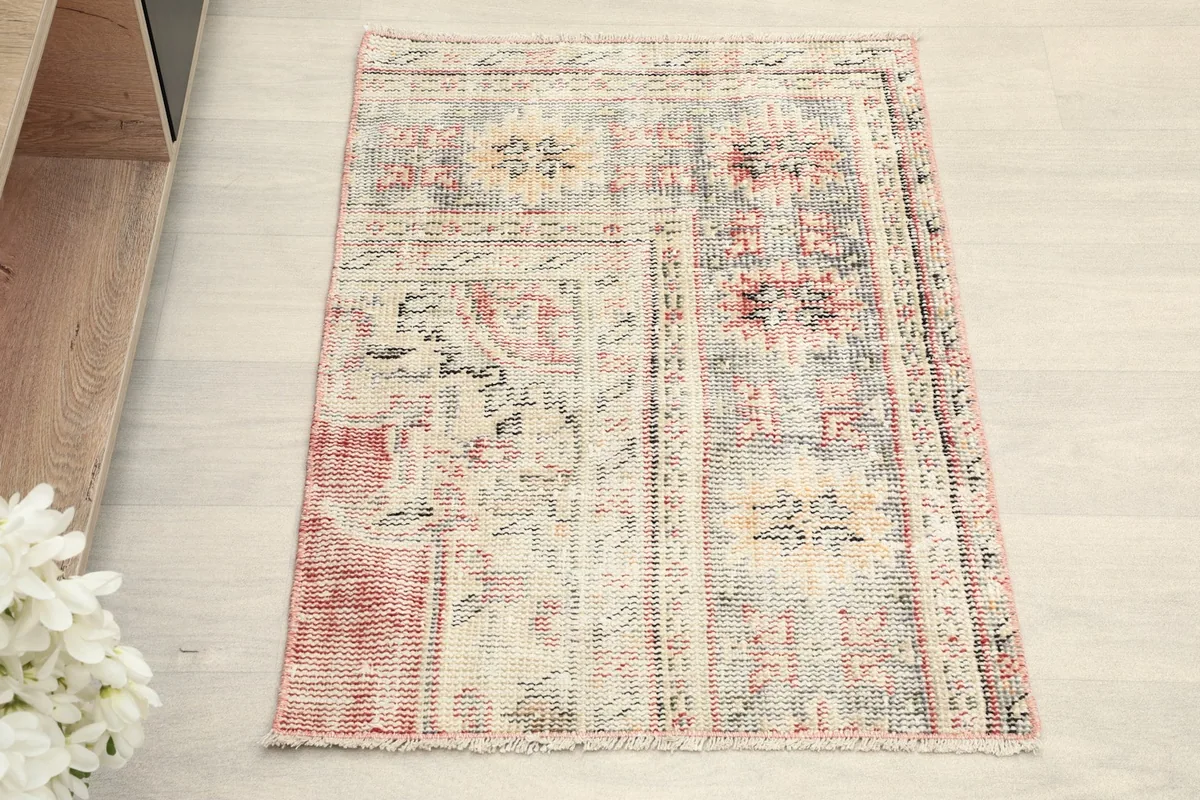 Overhead view of the hand-knotted wool rug, showing its geometric patterns and color variations.