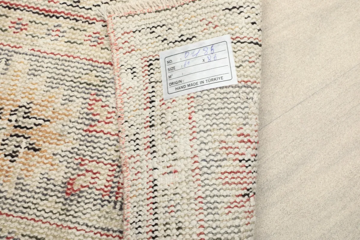 Close-up of the label on the back of the rug, confirming its hand-knotted origin in Turkey.