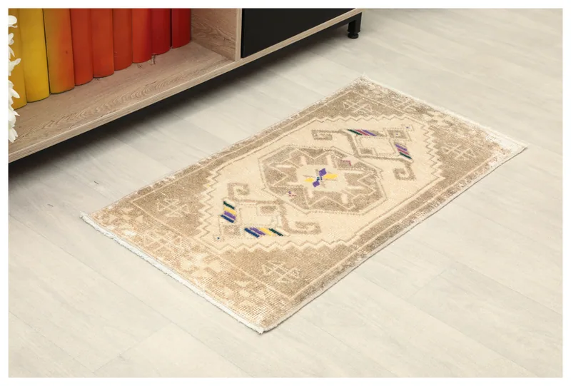 Full top view of the 1'6" x 2'11" ivory geometric medallion rug on a white background.
