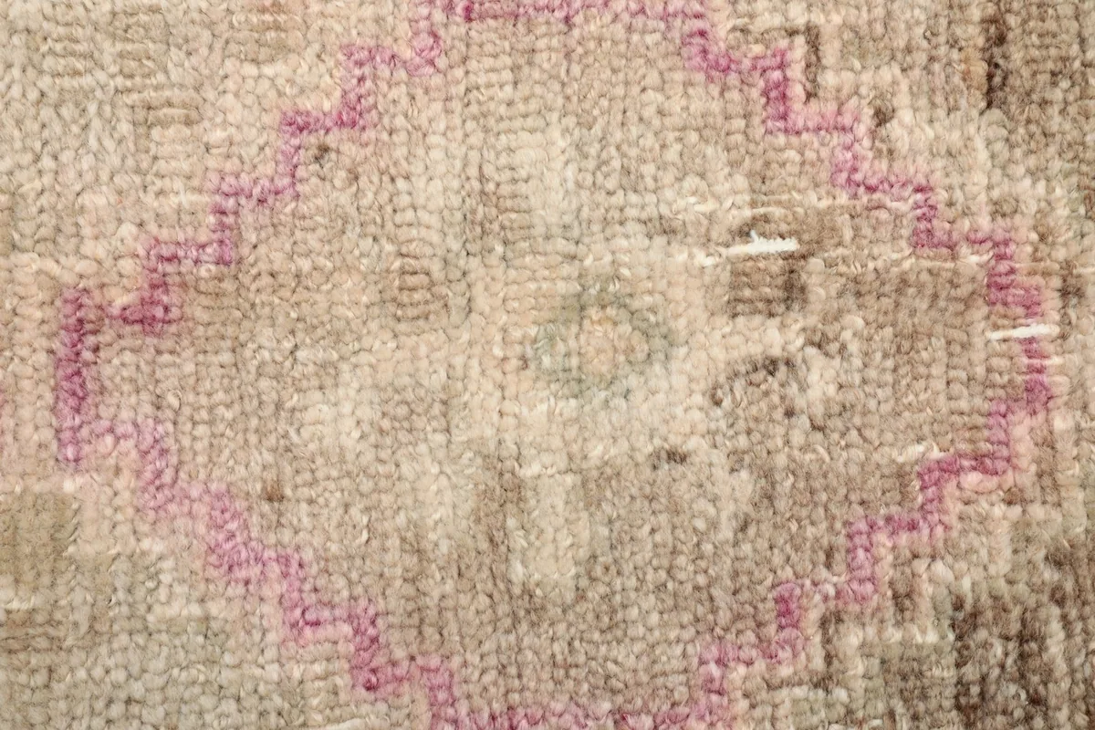 Detailed shot of the low wool pile, showing knots and texture of the rug