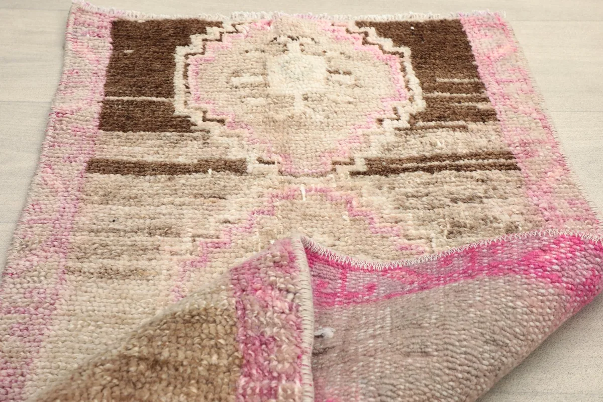 Rug folded back to reveal the backside and the hand-knotted construction