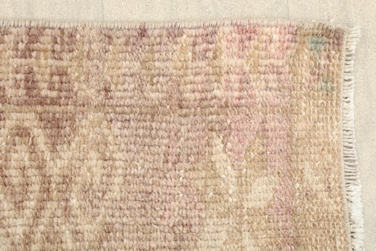 Edge detail of the hand-knotted rug, showcasing the tight weave and a hint of the fringe.