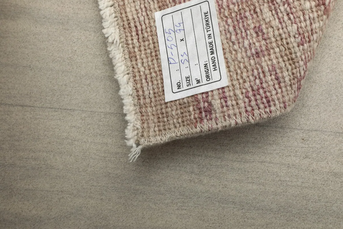 Close-up of the label on the back of the rug, indicating its origin and size.