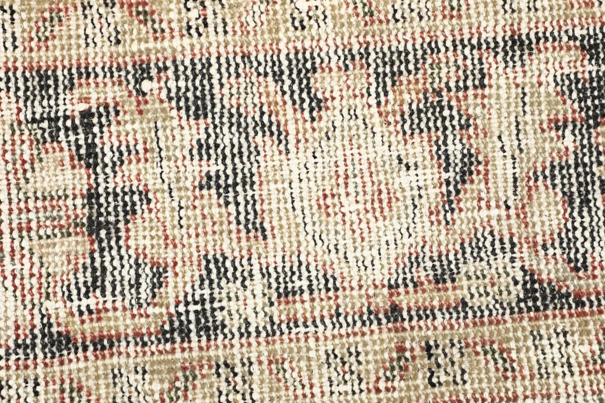 Close-up detail of the intricate black and beige motifs within the rug's design