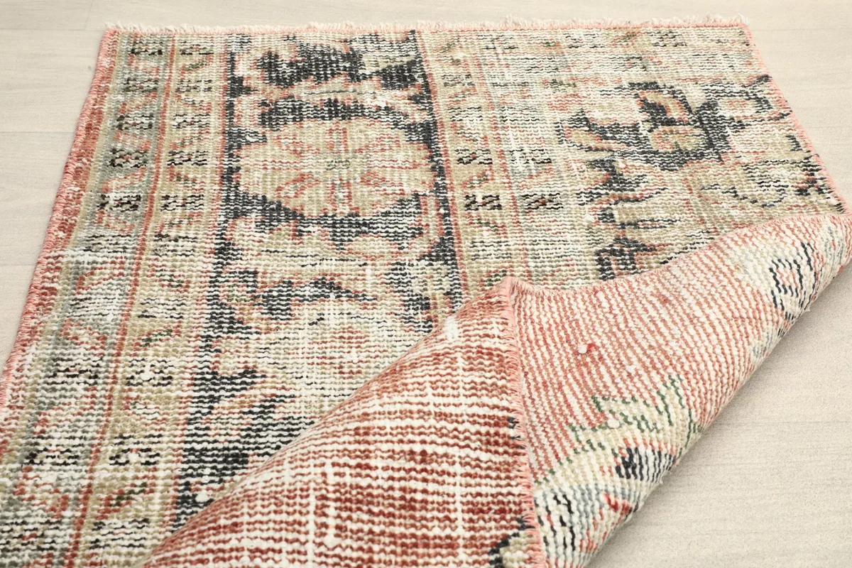 Folded corner of the rug, illustrating its flexibility and construction
