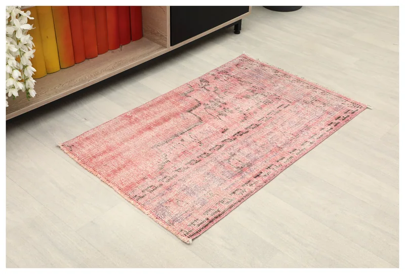 Full top view of the 2x3 rose and black distressed geometric rug on a light floor.