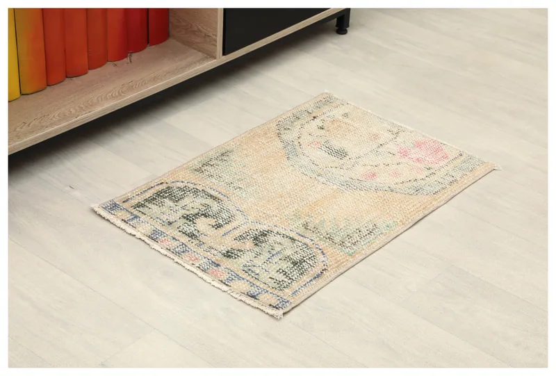 Full top view of the beige vintage Anatolian doormat with tribal motifs on a white background.