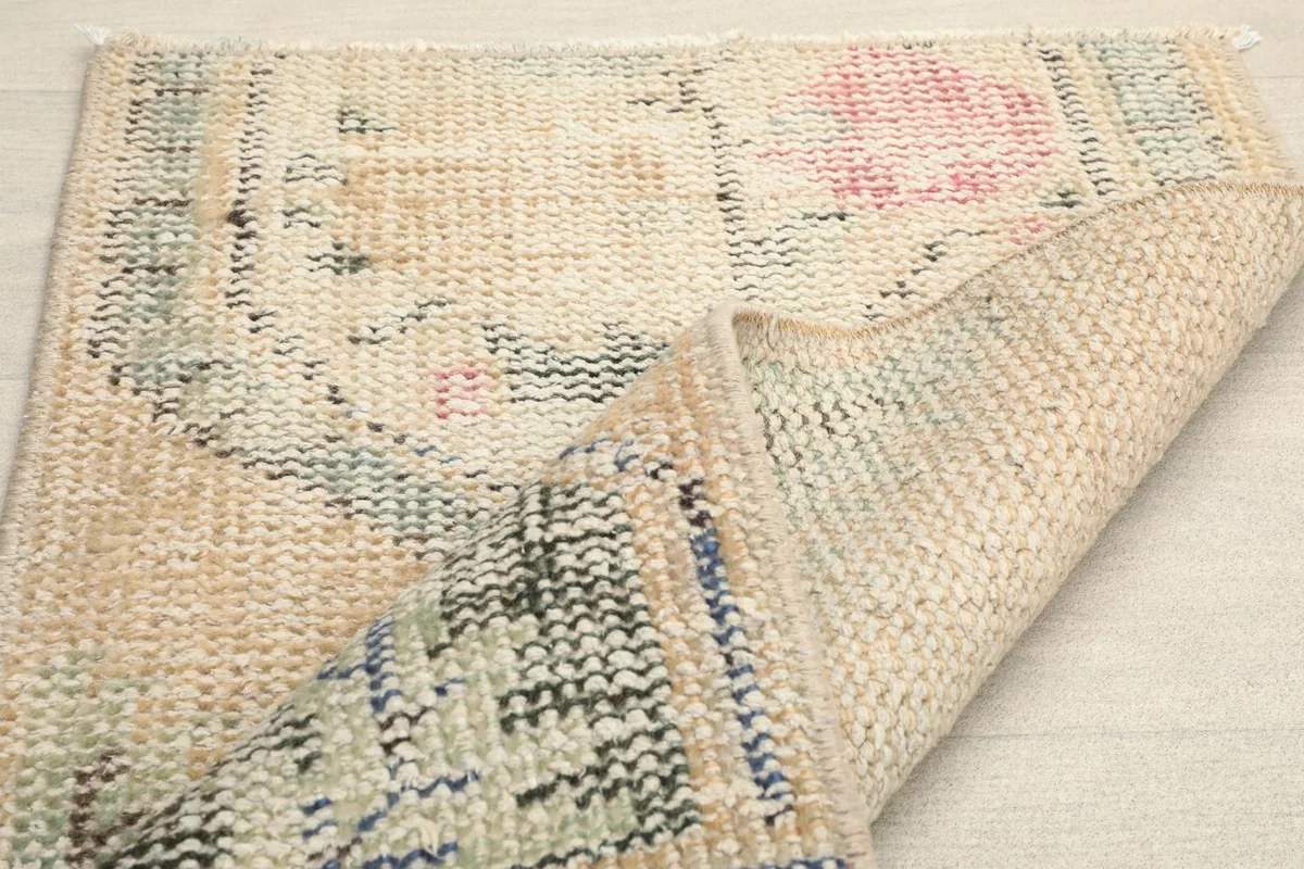Another folded view of the rug, illustrating the wool pile and cotton foundation.