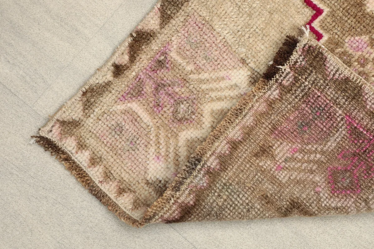 View of the back of the hand-knotted rug, revealing the cotton foundation and knot structure.