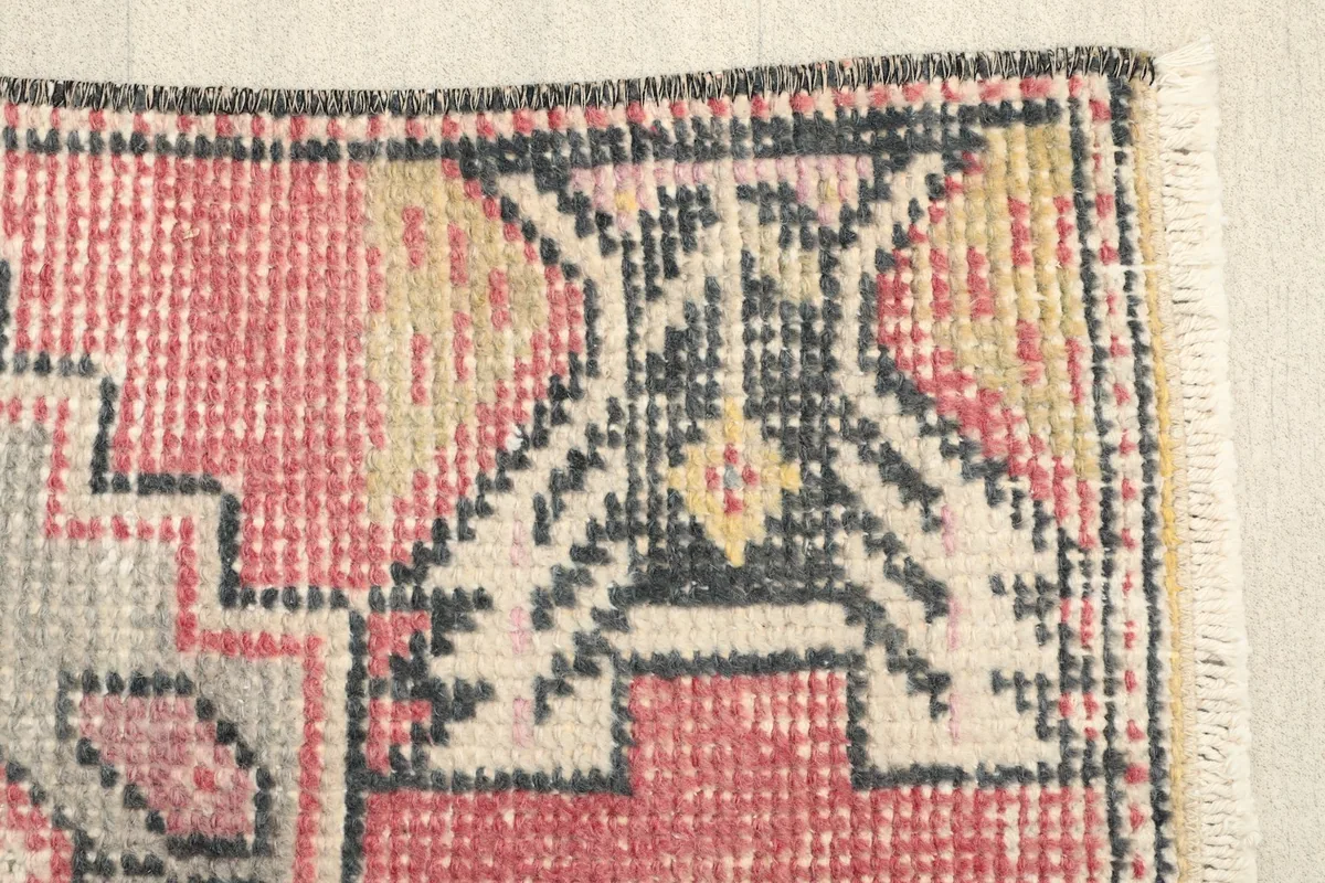 Close-up of the geometric tribal design at the edge of the rug