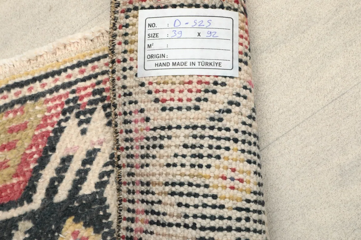 Reverse side of the hand-knotted rug with a label showing dimensions and origin