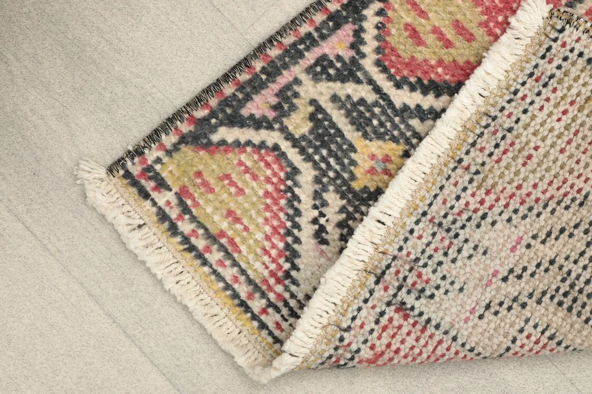 Folded corner showing the wool pile texture and cotton foundation