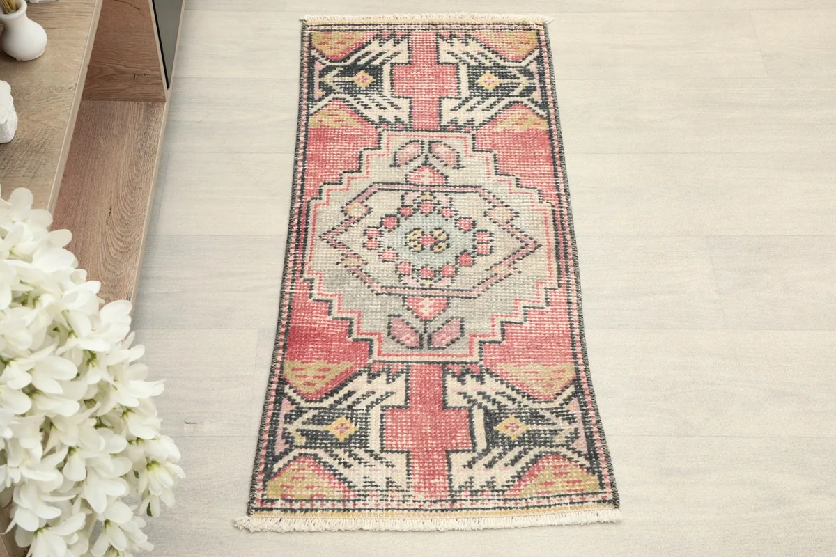 Overhead view of the small rose and gray hand-knotted rug