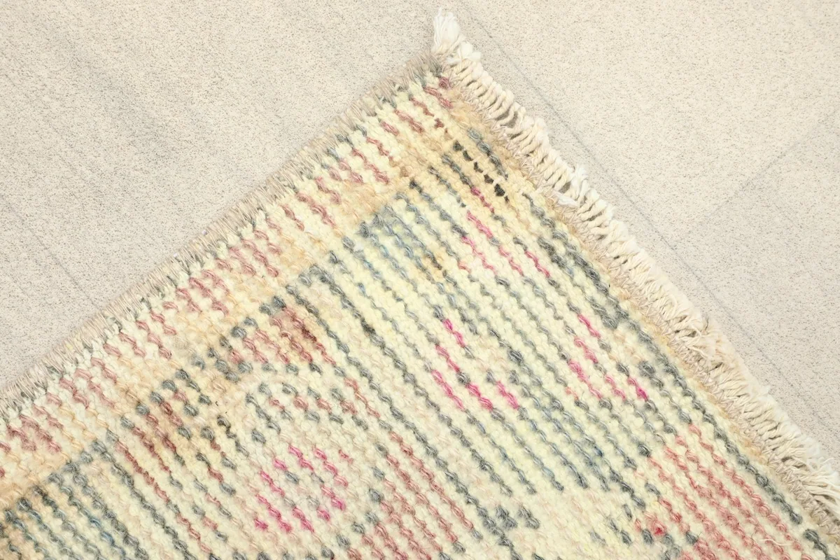 Corner detail showing the fringe and textural variations of the wool pile