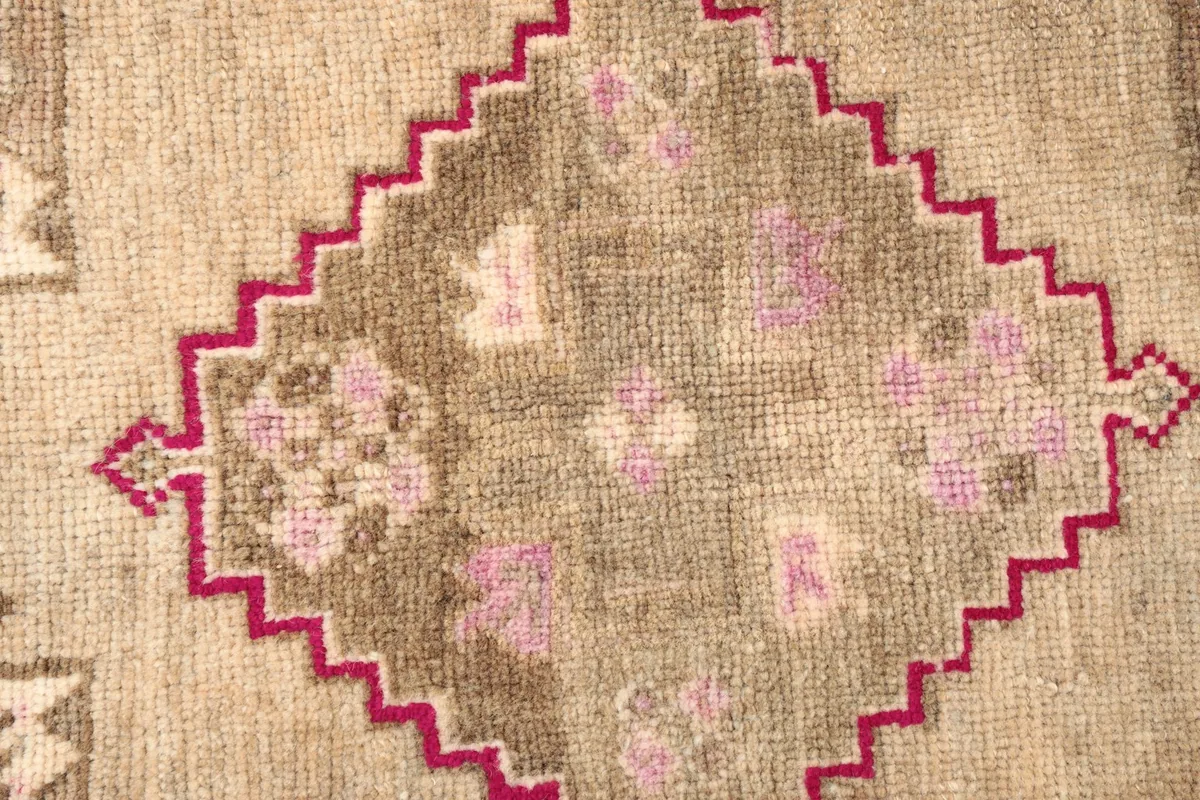 Detailed shot of the central medallion with rose and light brown patterns.