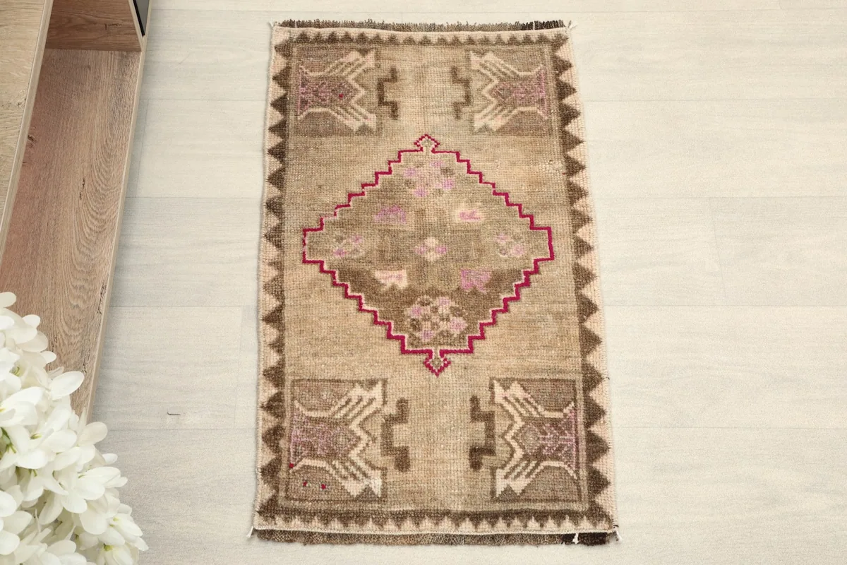Overhead view of the vintage rug, showing its full design and colors.
