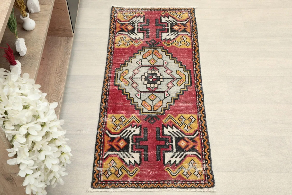 Overhead view of the red and gray tribal doormat, showcasing its full design and colors.