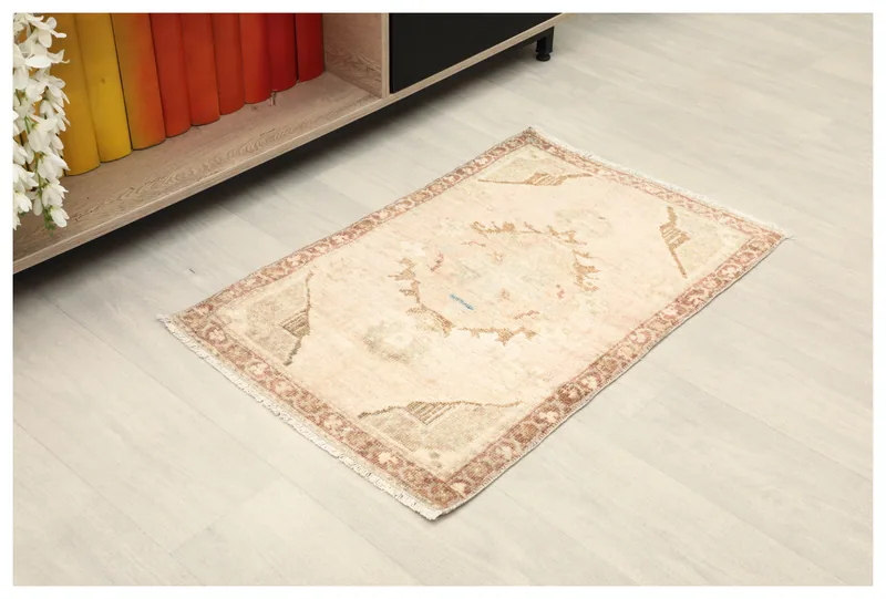 Full top view of the beige and rust vintage Anatolian doormat