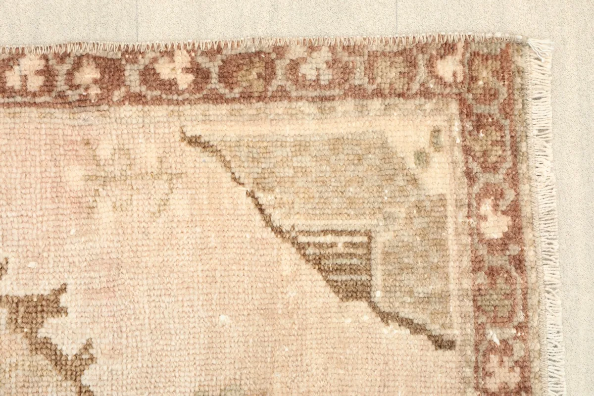 Close-up of a corner motif and the patterned border, displaying the rug's texture
