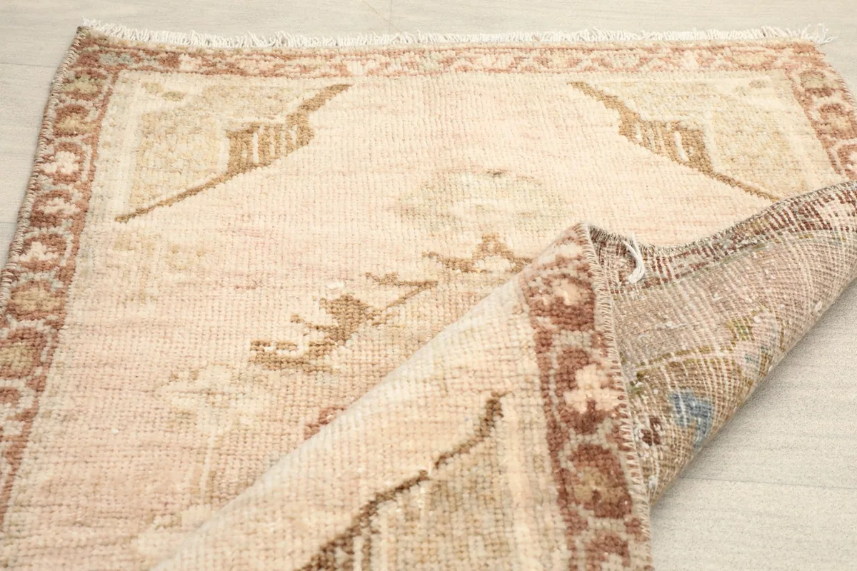 Close-up of the low wool pile and the hand-knotted construction of the vintage rug