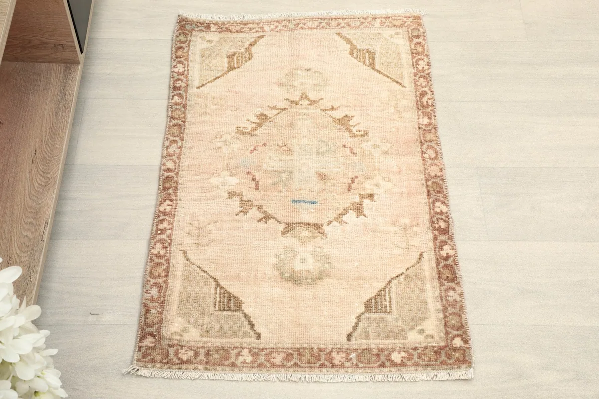 Overhead view showcasing the beige field and rust geometric patterns of the rug