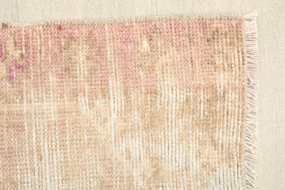 Corner view of the hand-knotted rug, revealing the texture and the subtle color shifts in the pile.