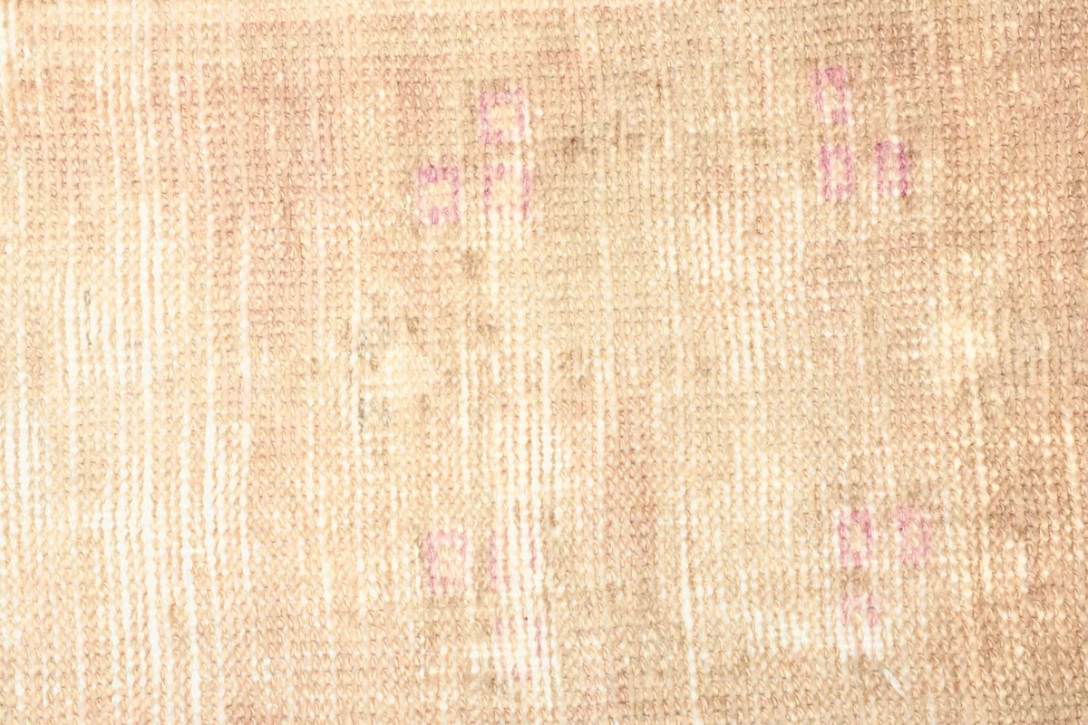 Texture detail of the low wool pile, highlighting the distressed appearance and color variations.