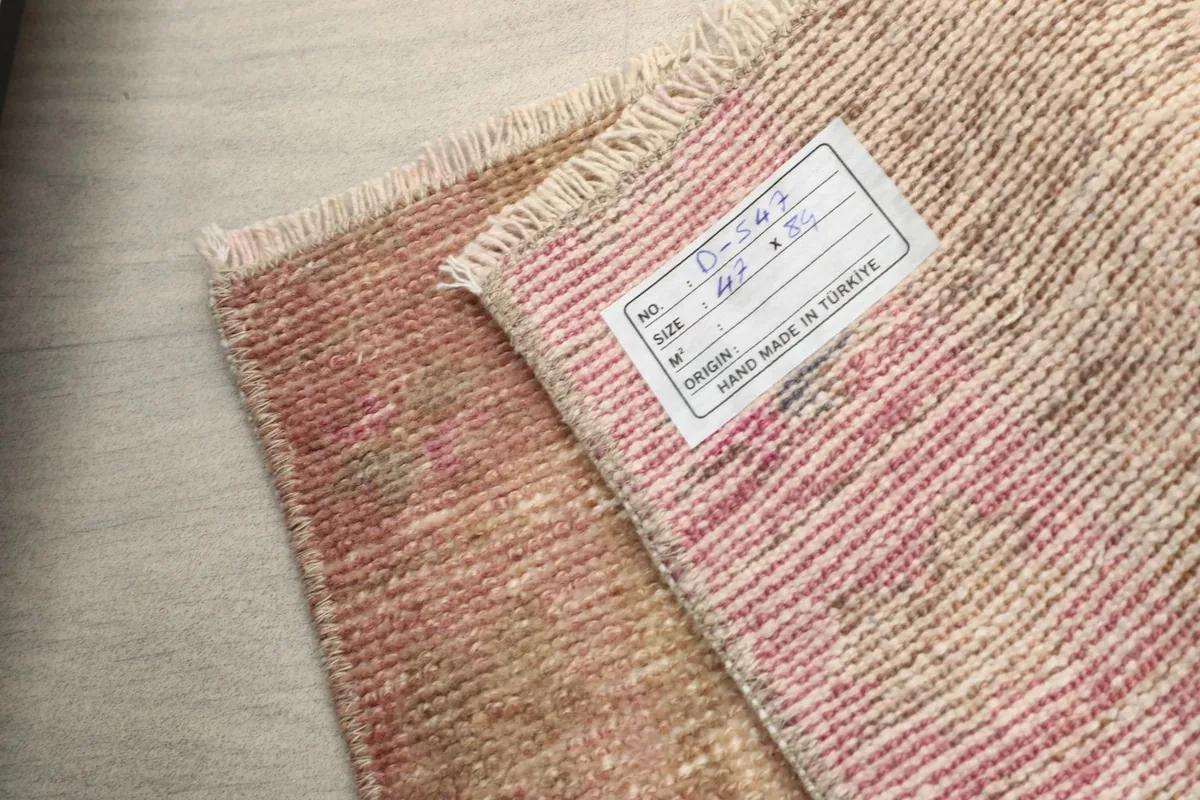 Close-up of the label on the back of the rug, confirming its origin and hand-made quality.