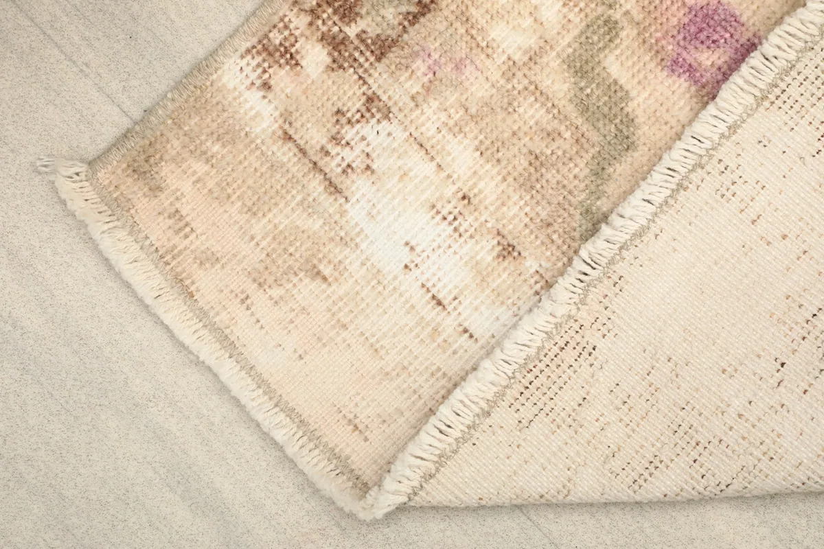 View of the rug's reverse side, showing the cotton foundation and hand-knotted construction.