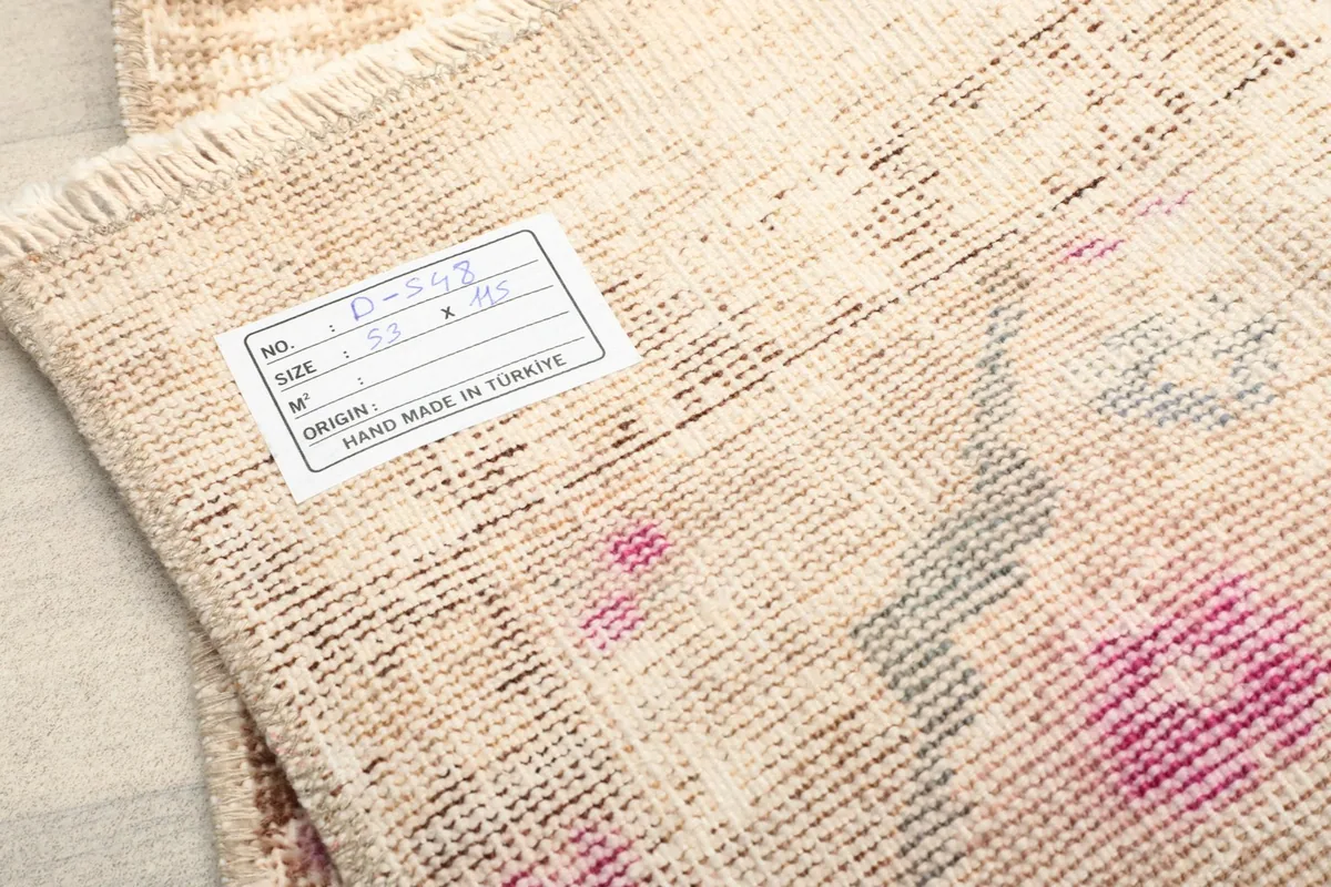 Close-up of the label on the back of the rug, detailing size and origin.