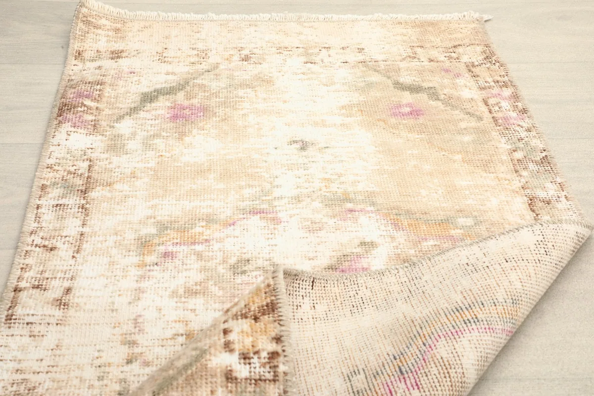 The rug folded back to reveal both the pile and the woven back, indicating its flexibility.