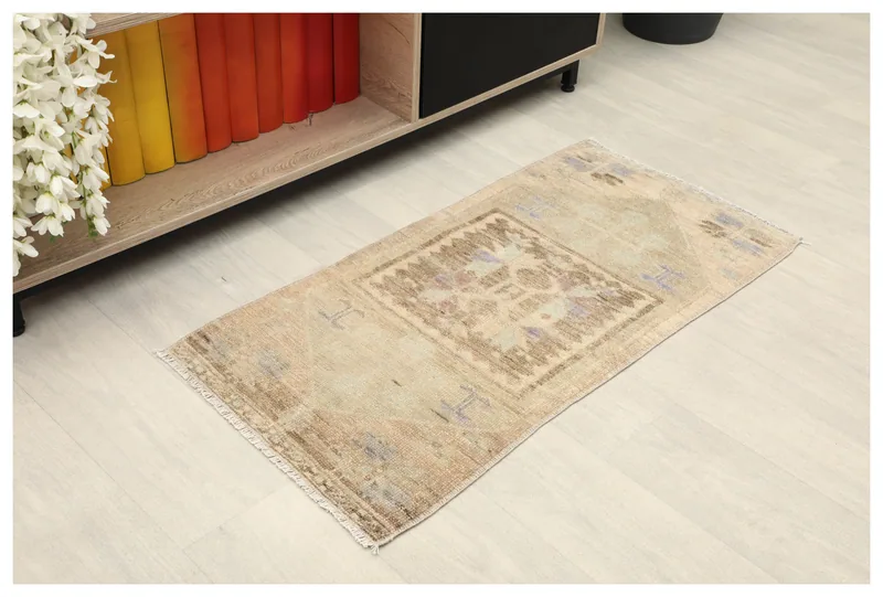 Full overhead view of the beige vintage Anatolian rug with a central tribal medallion.