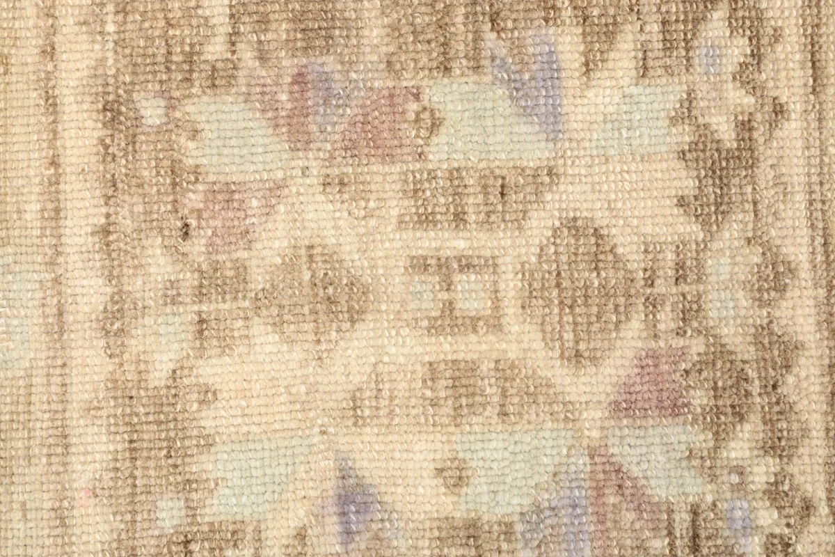 Extreme close-up showing the intricate geometric patterns and wool pile texture.