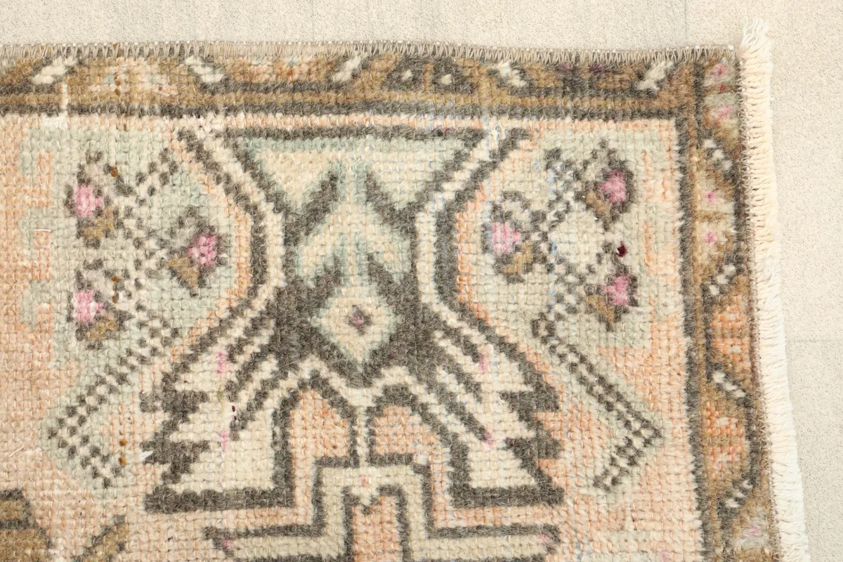 Close-up of the rug's edge, highlighting the intricate tribal patterns and colors.